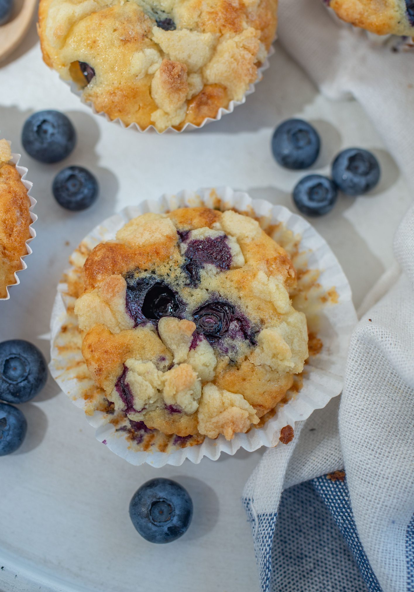 A blueberry muffins on a white cloth in the table